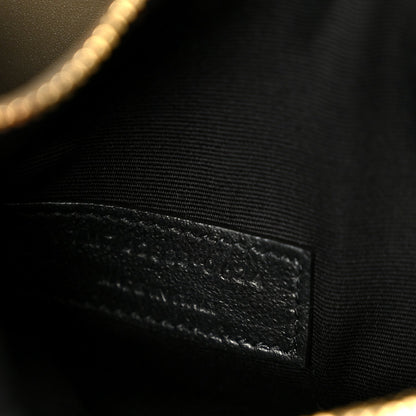 Saint Laurent interior lining detail with stitched leather edge in dark tone.