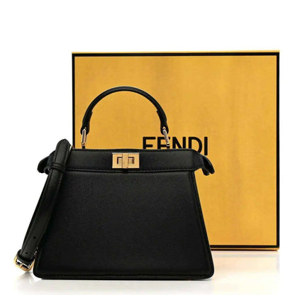Black leather mini satchel with gold-toned clasp and top handles