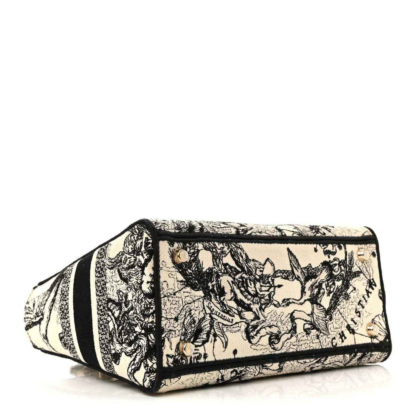 Structured mini tote handbag with toile scene print and black trim, top flap closure.