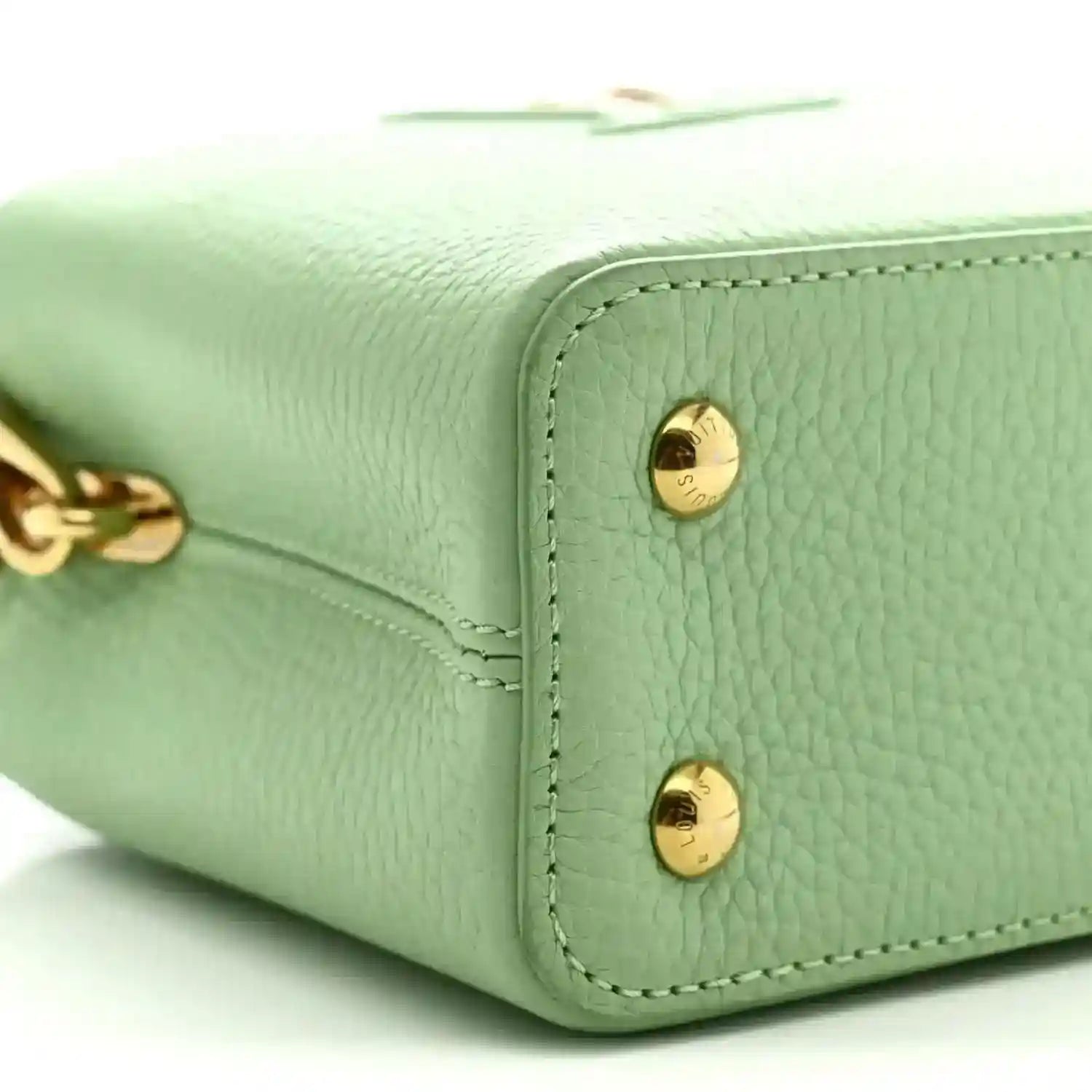 Louis Vuitton mini Capucines leather handbag, vert pomme green, close-up of gold snap hardware