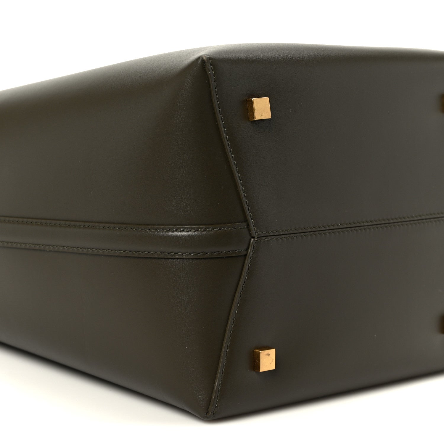 Shiny bucket bag side panel with stitched panels and gold square studs.