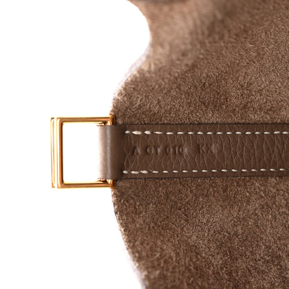 Leather belt strap with gold rectangular buckle and white stitching.