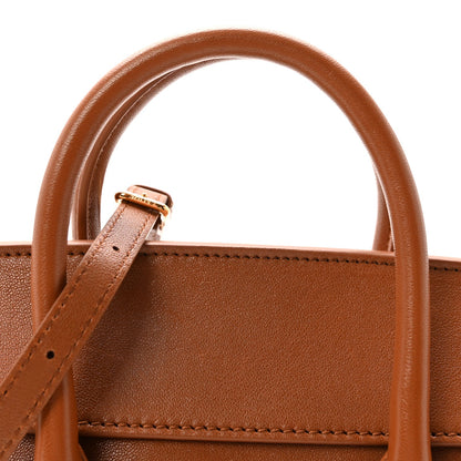 Tan leather tote handle attachment with small metal buckle