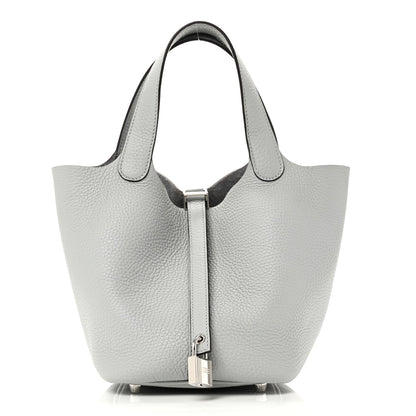 Light blue pebbled leather tote bag with top handles and front lock closure