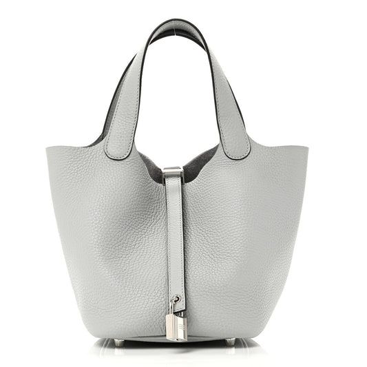 Light blue pebbled leather tote bag with top handles and front lock closure
