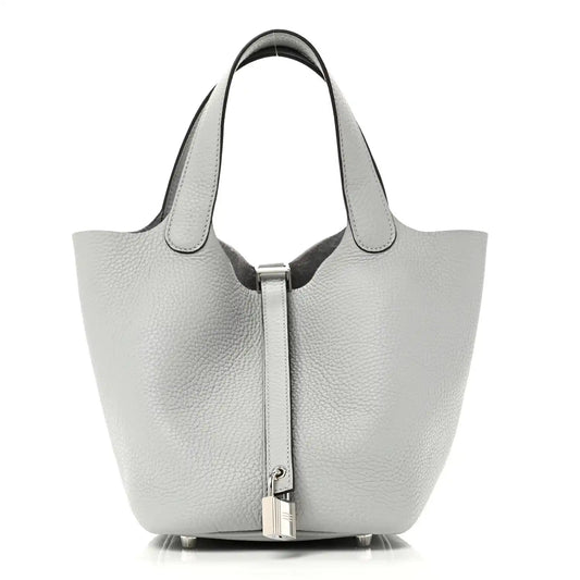 Light blue pebbled leather tote bag with top handles and front lock closure
