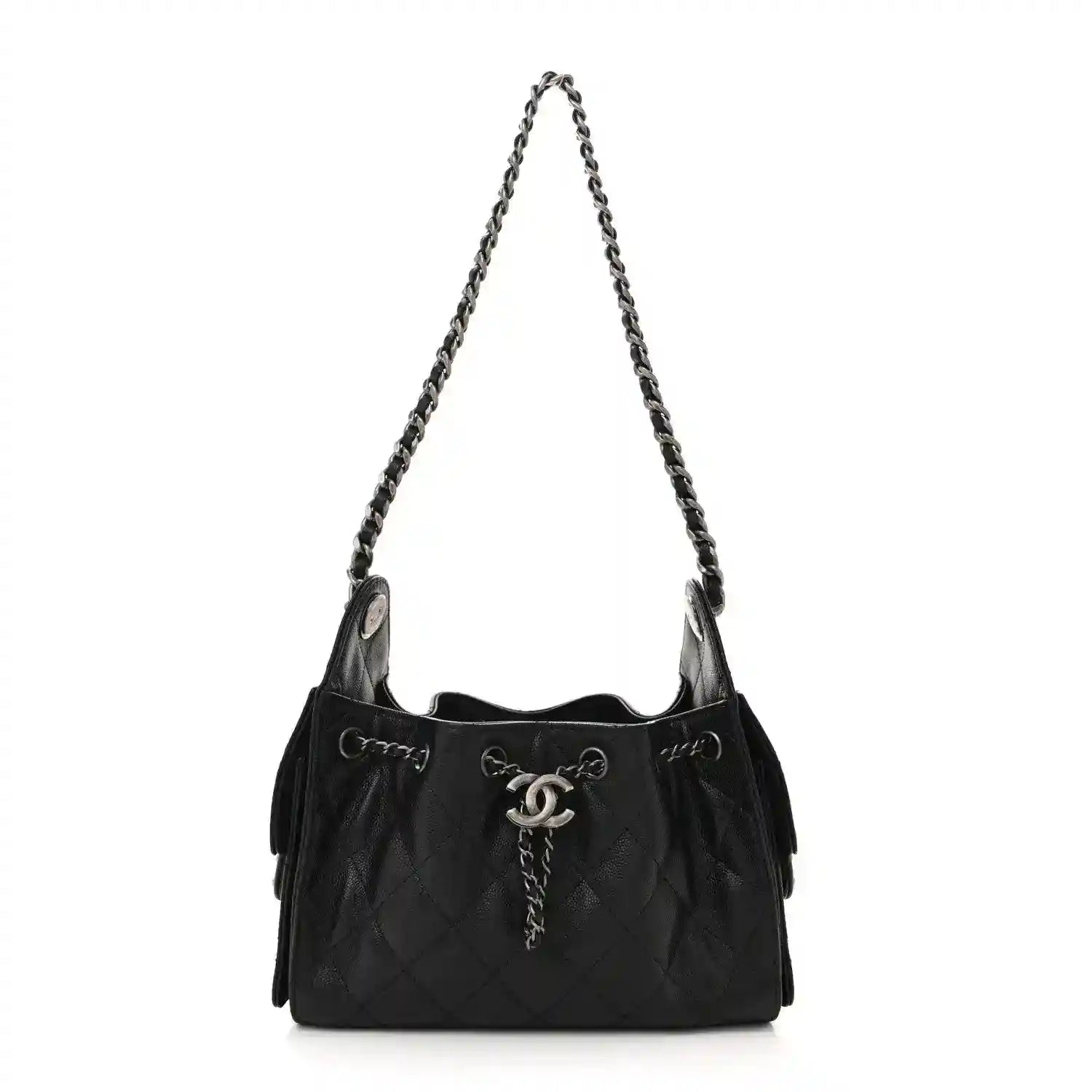 Black quilted mini shoulder bag with chain strap and CC clasp, ruthenium hardware.