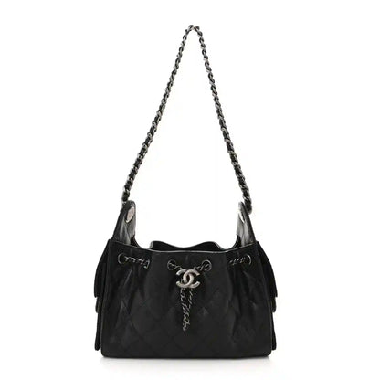 Black quilted mini shoulder bag with chain strap and CC clasp, ruthenium hardware.