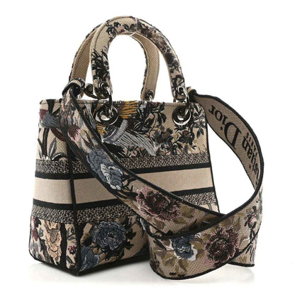 Floral embroidered canvas tote with top handles and crossbody strap, with logo band.
