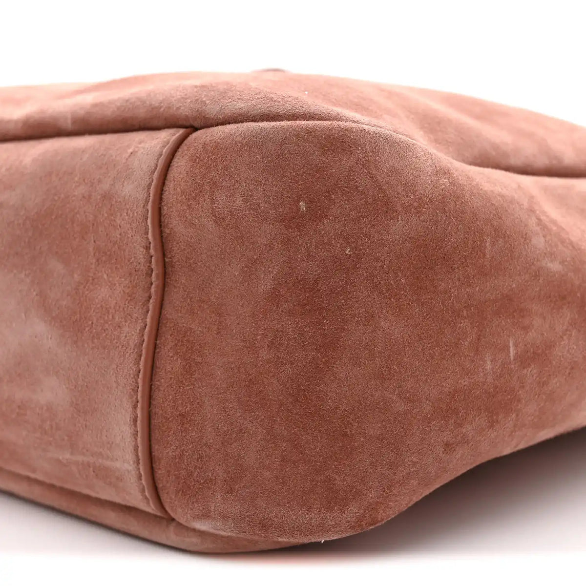 Small suede hobo bag close-up of end panel seam and textured suede surface