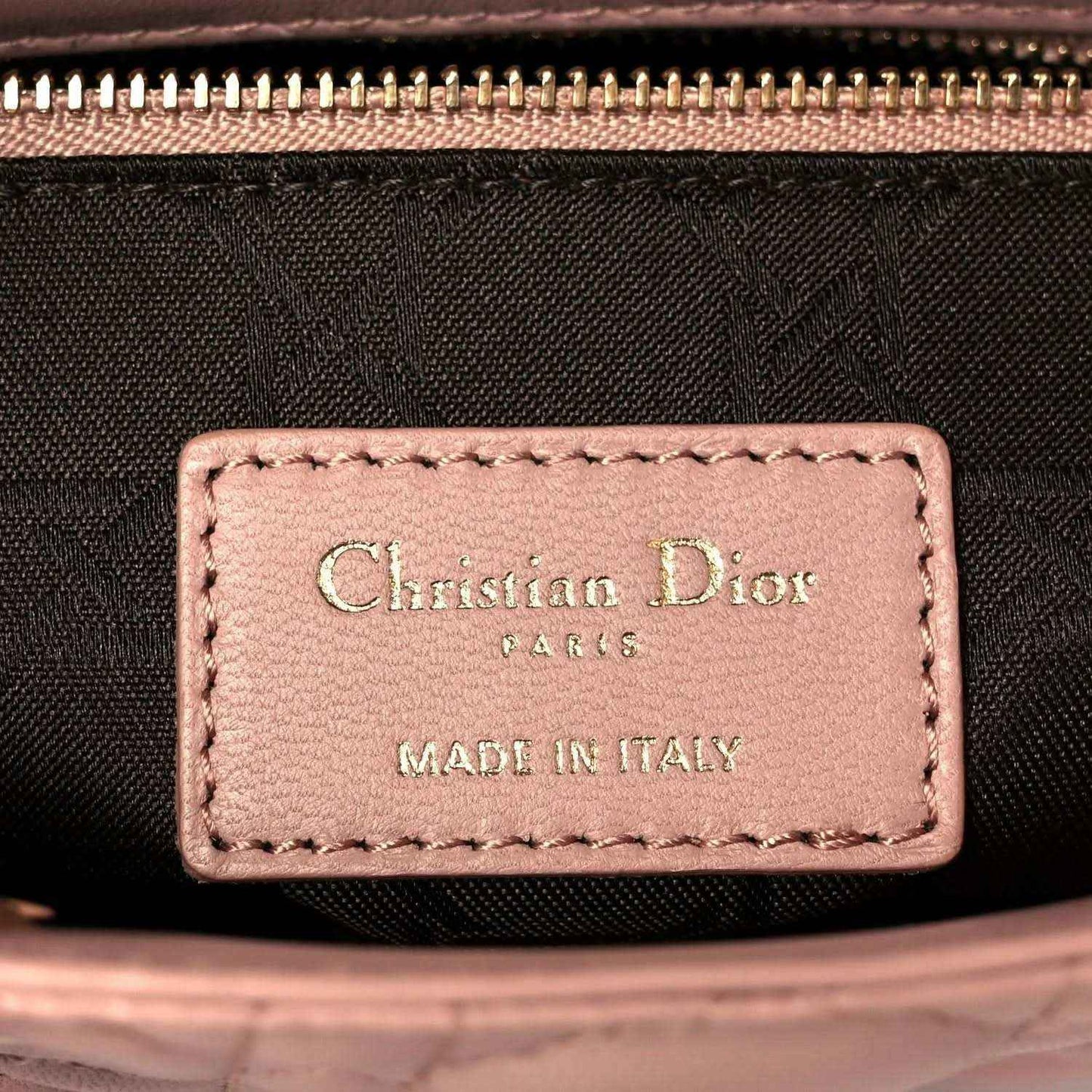 Lining label with Christian Dior Paris and Made in Italy text on pink leather