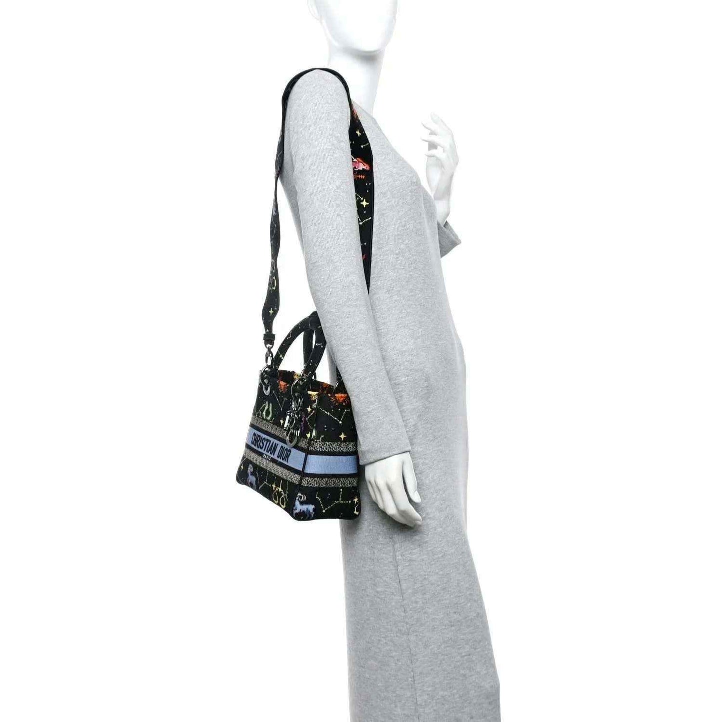 Black canvas handbag with zodiac embroidery and shoulder strap with light blue stripe