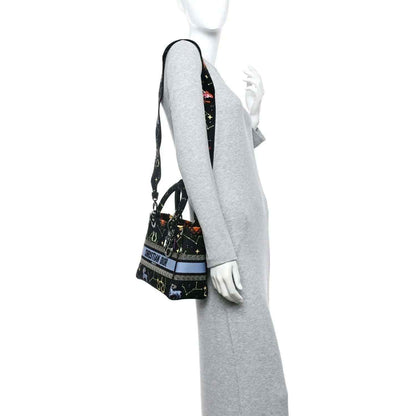 Black canvas handbag with zodiac embroidery and shoulder strap with light blue stripe
