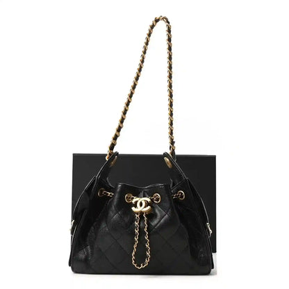 Quilted mini handbag in black leather with gold chain handles and drawstring top, logo charm