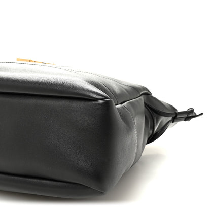 Black lambskin tote corner with drawstring bow ties and smooth rounded edge.