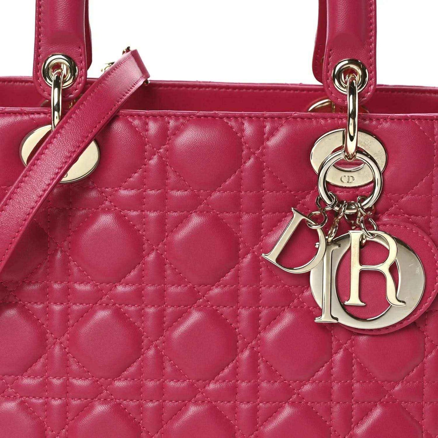 Fuchsia quilted leather handbag front with top handle rings and Dior charm