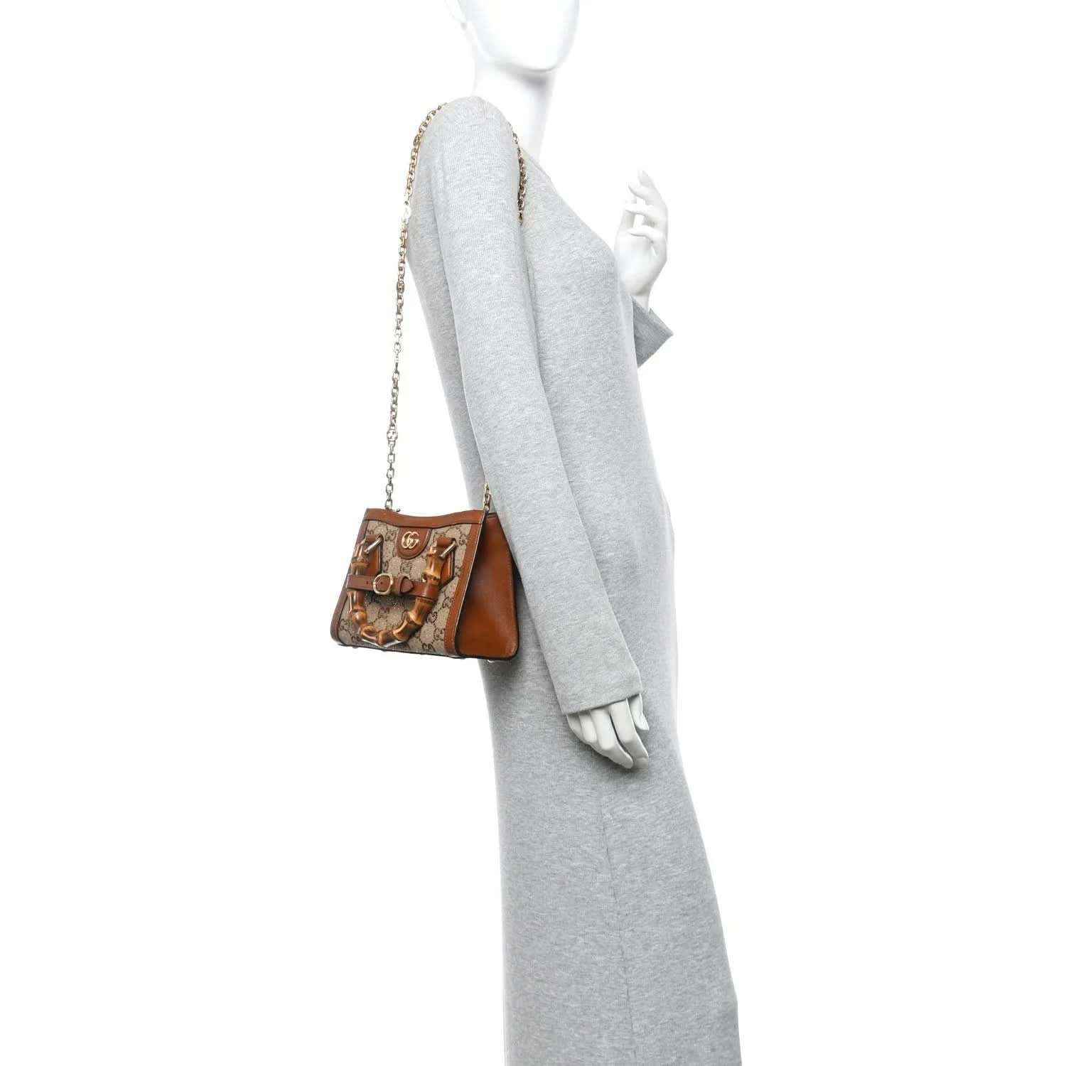 Gucci mini tote bag in tan and brown with GG canvas, chain strap, on shoulder.