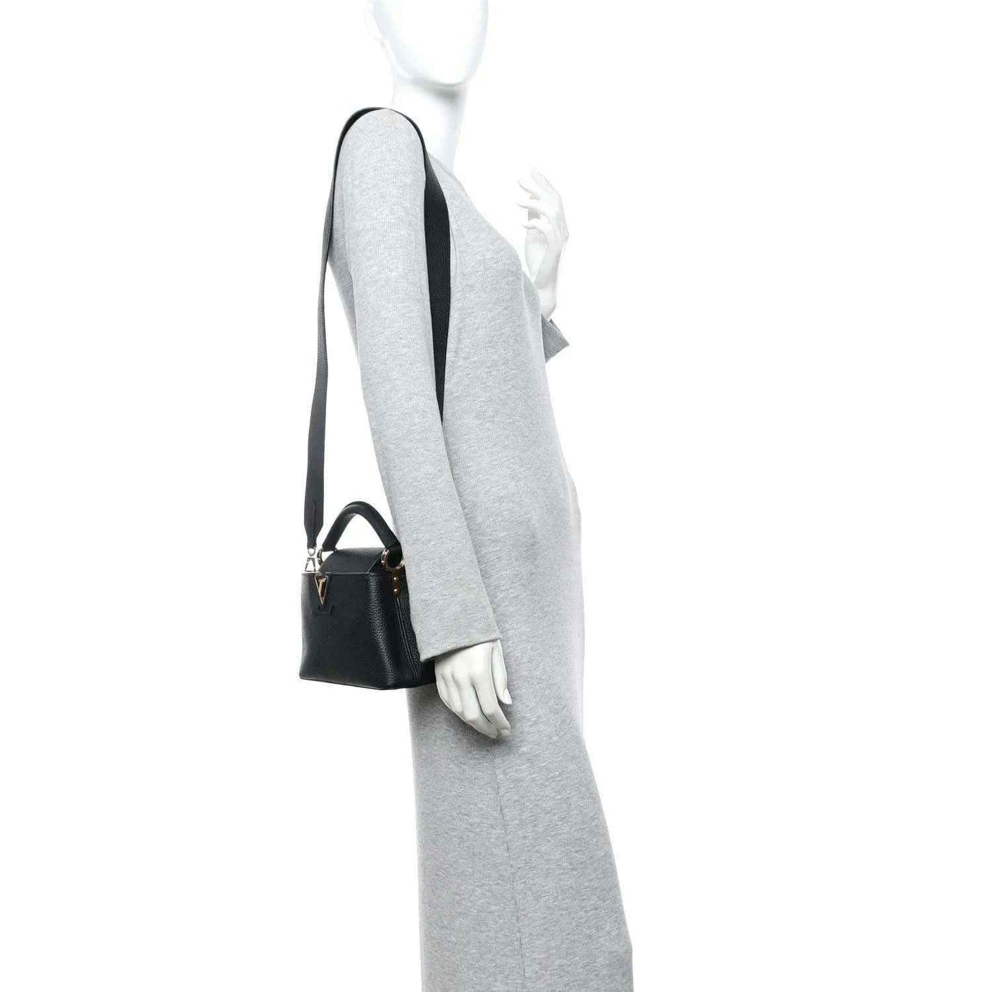 Black leather mini handbag worn crossbody with adjustable strap