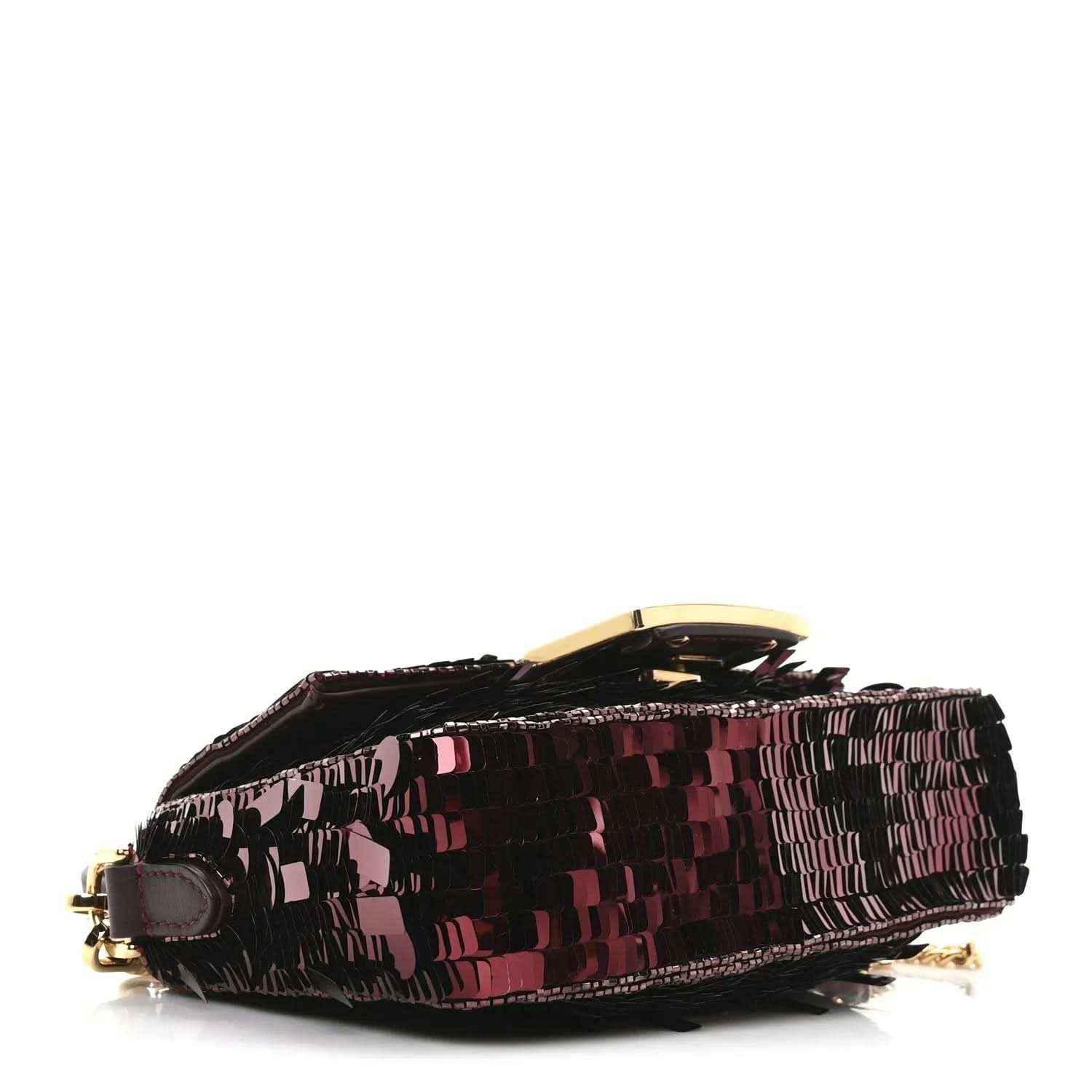 Mini baguette handbag side profile with red sequin texture and gold-toned hardware detail