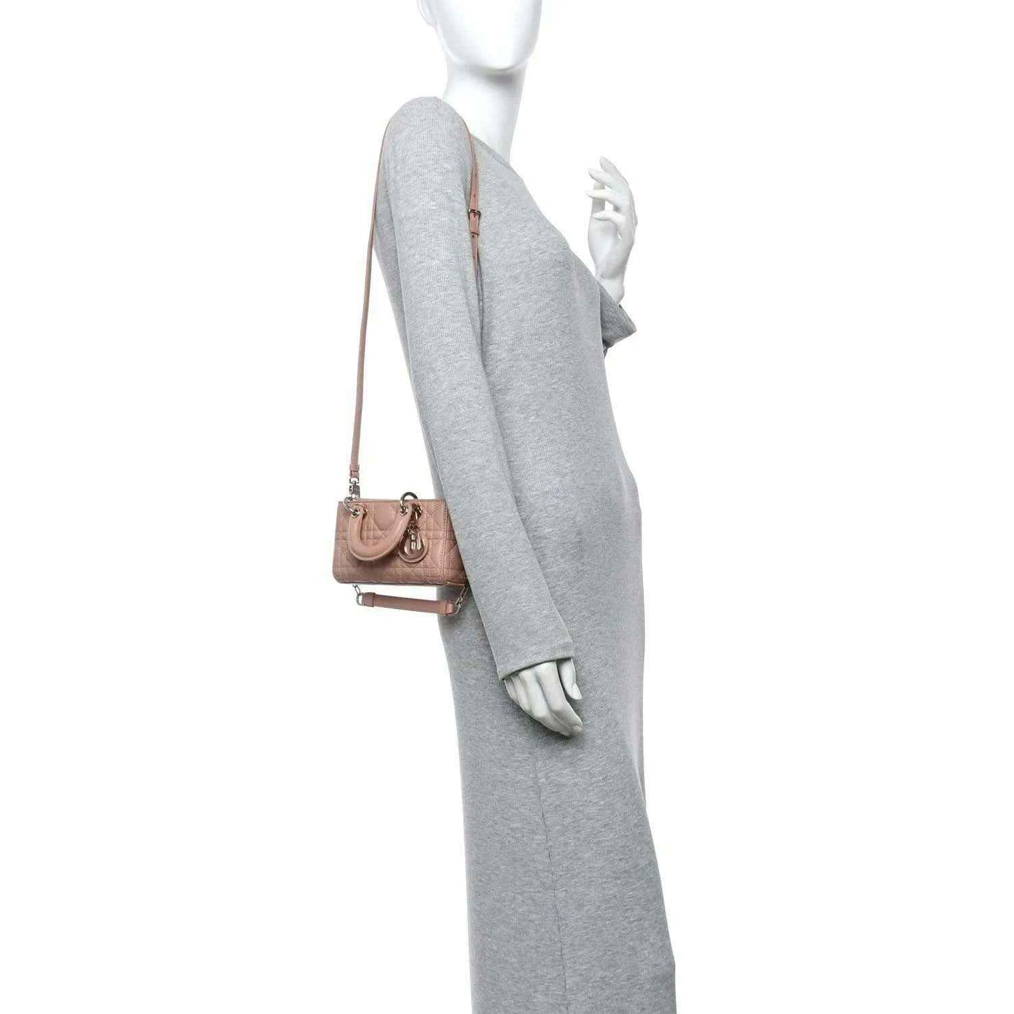 Pink beige micro handbag with shoulder strap and quilted cannage front, worn on model