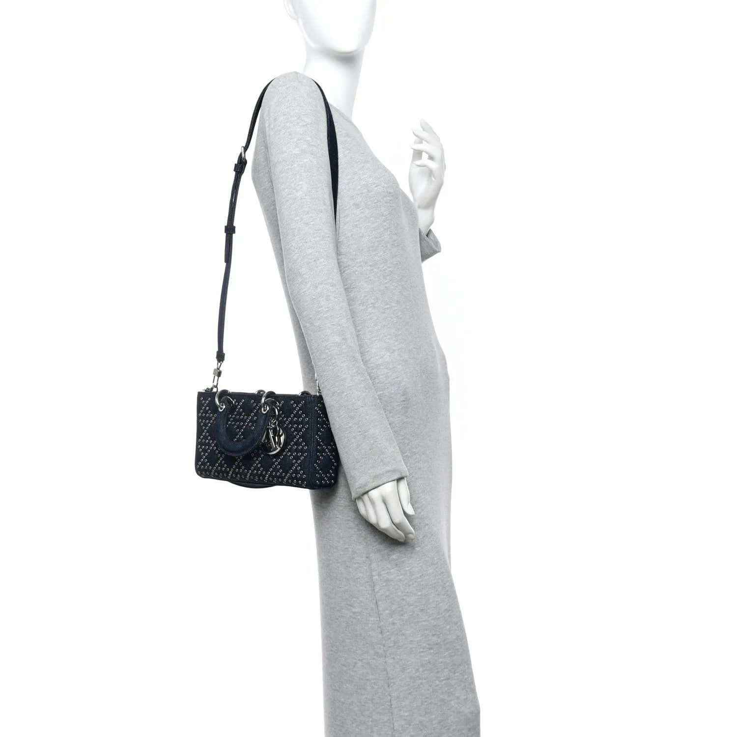 Denim eyelet crossbody mini bag in dark blue with adjustable strap and top handle