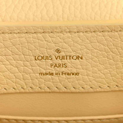 Cream leather interior panel with Louis Vuitton Paris and made in France text.