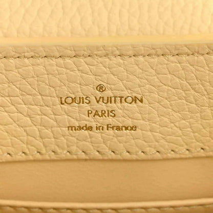 Cream leather interior panel with Louis Vuitton Paris and made in France text.