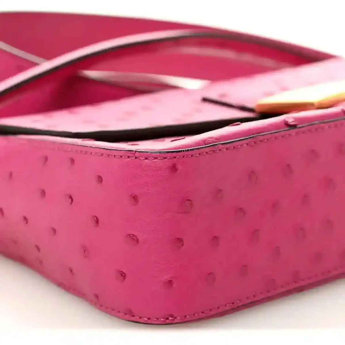 Pink ostrich leather baguette with black strap and gold-tone edge detail