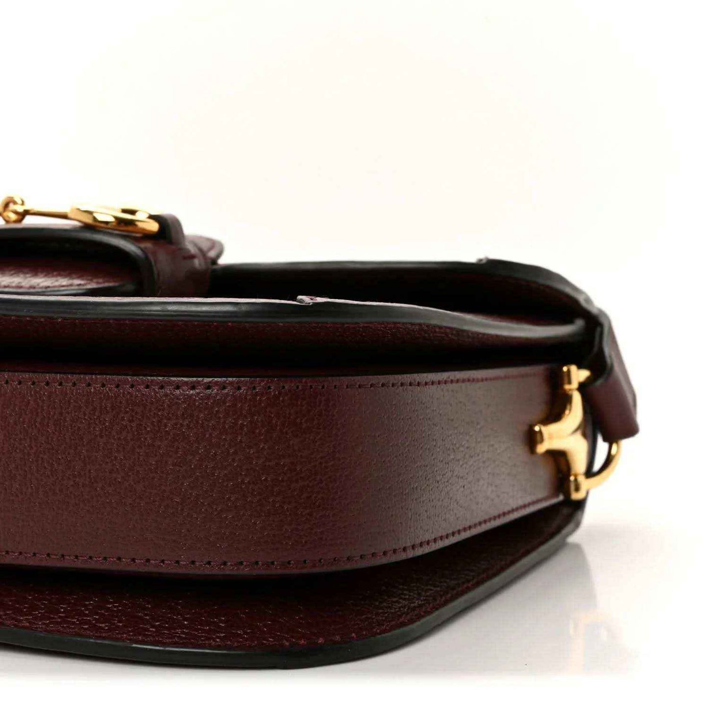 Gucci shoulder bag close-up side view with burgundy leather panel and gold clasp