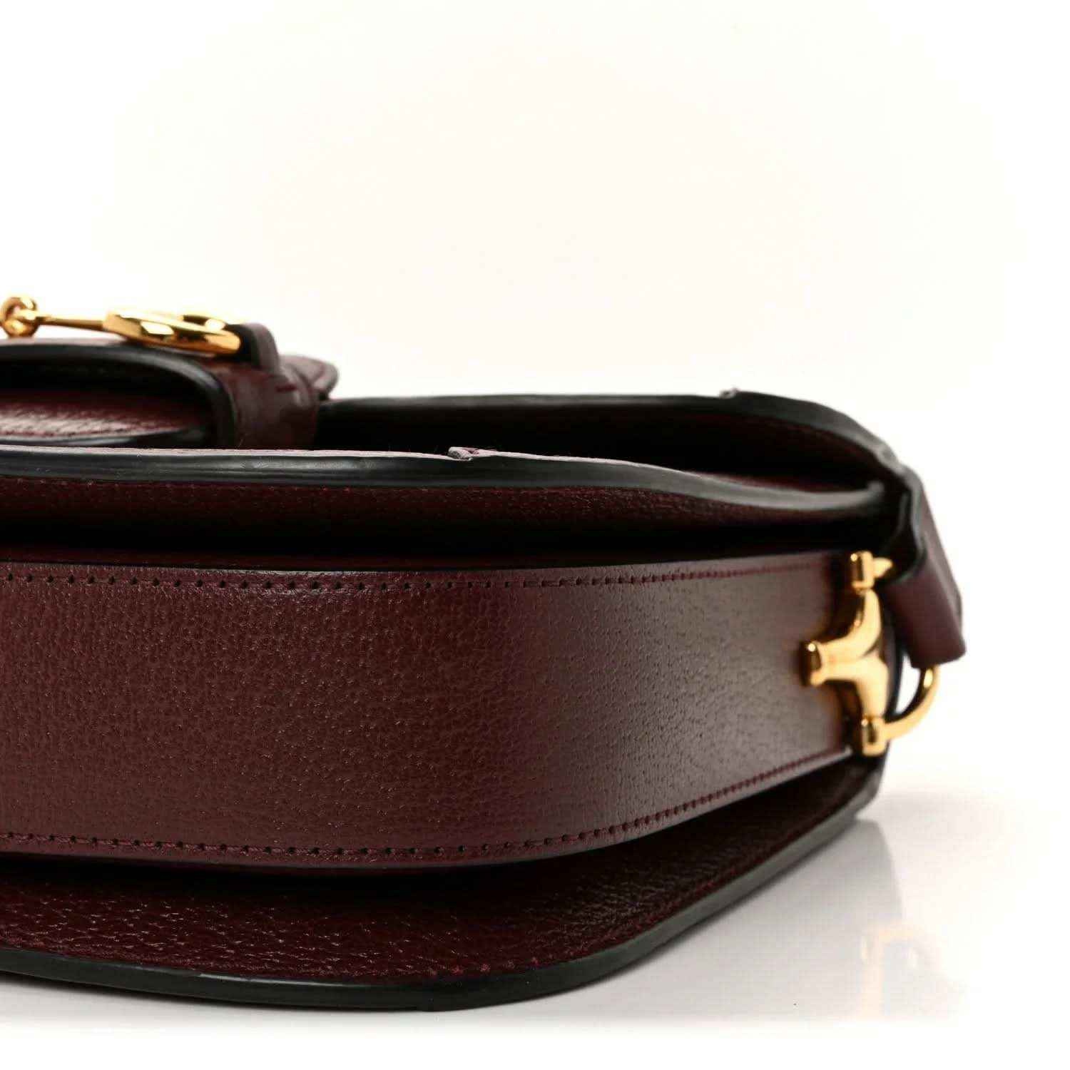 Gucci shoulder bag close-up side view with burgundy leather panel and gold clasp
