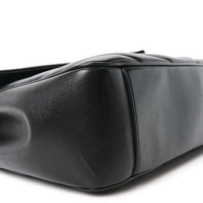 Black quilted lambskin shoulder bag side with rounded base