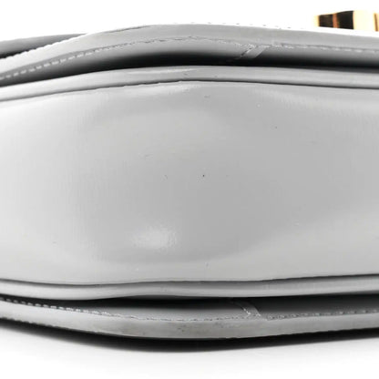 Shiny calfskin bag side panel close-up with stitched edge