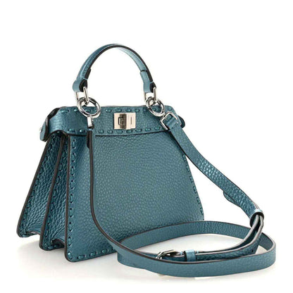 Blue leather petite satchel with front turn-lock clasp and adjustable crossbody strap.