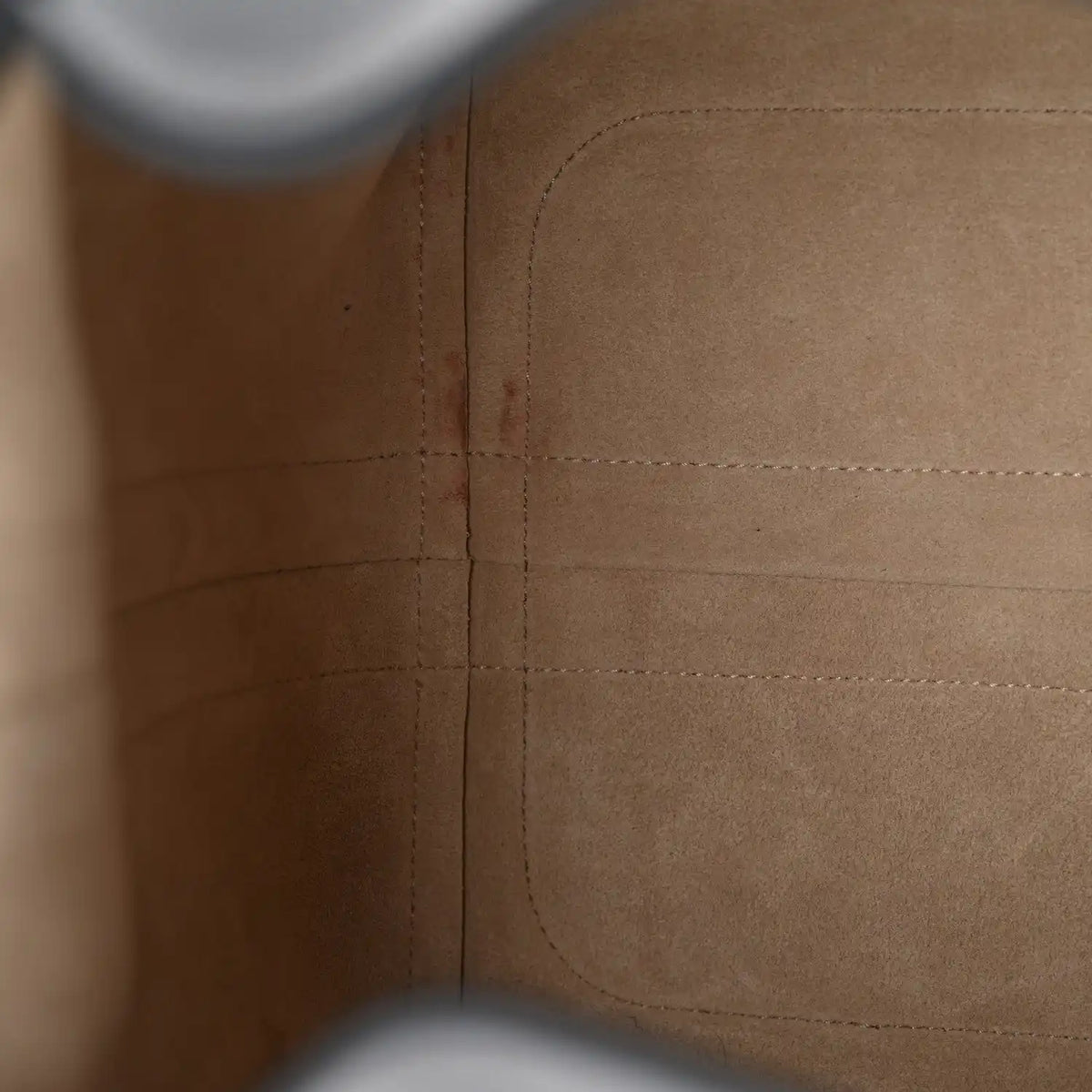 Tan interior lining close-up with stitched panels and reinforced seam lines