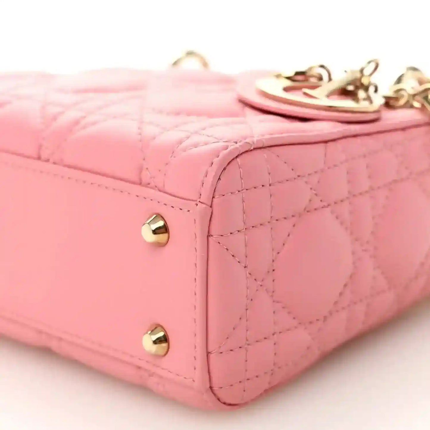 Light pink quilted mini Lady Dior handbag corner with gold studs and top detail