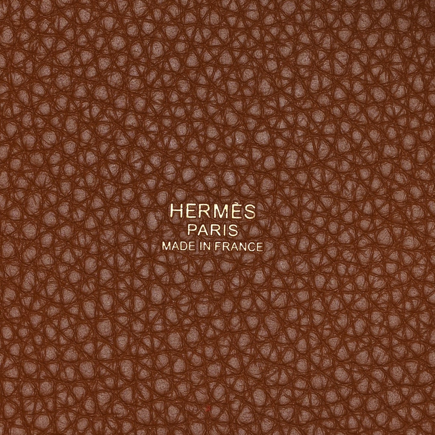 Leather lining close-up with embossed text and brown pebbled texture