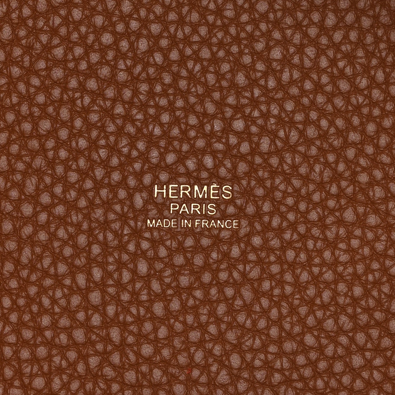 Leather lining close-up with embossed text and brown pebbled texture