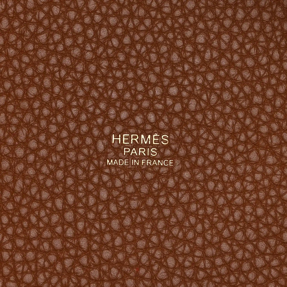 Leather lining close-up with embossed text and brown pebbled texture