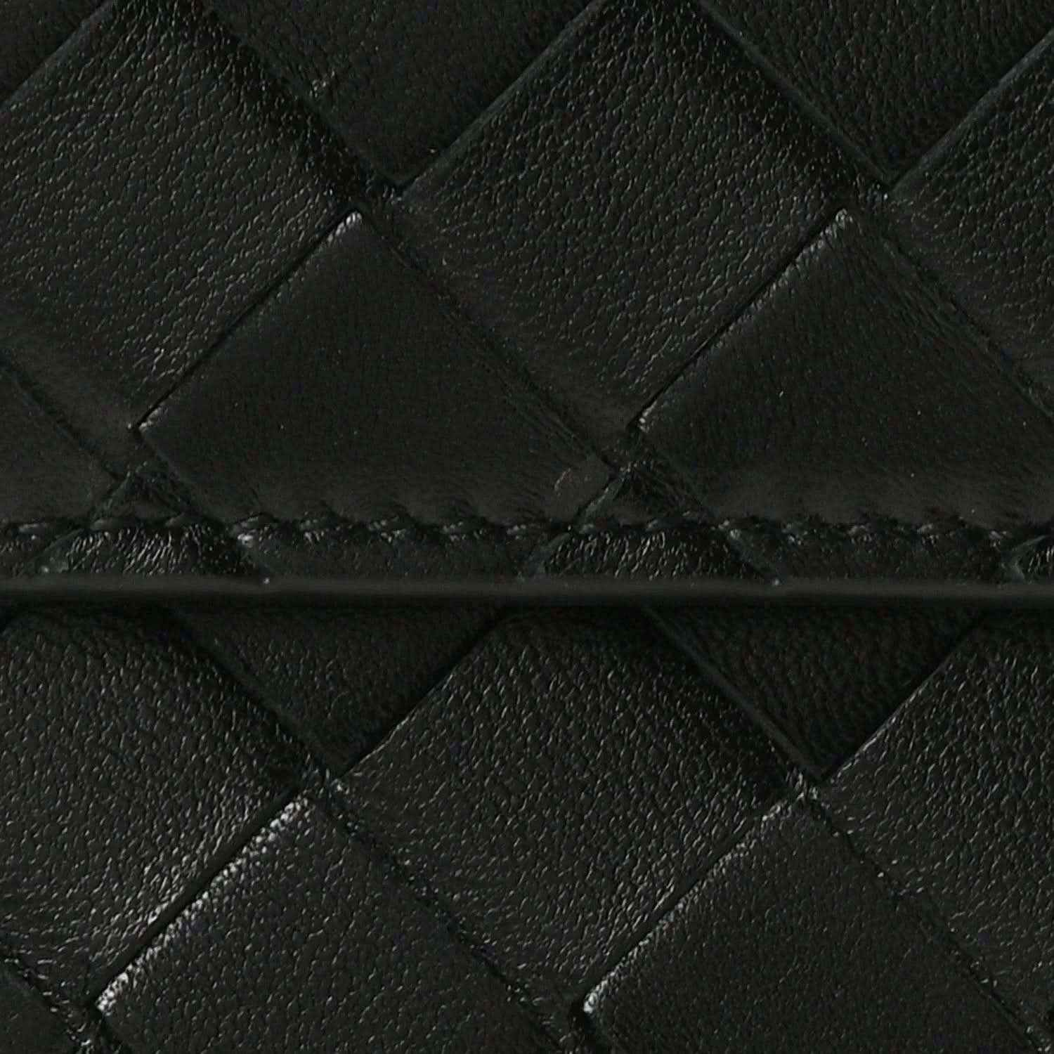 Close-up of black intrecciato woven leather clutch pattern