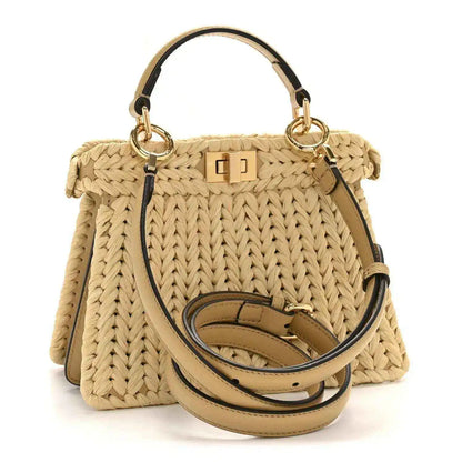 Petite raffia satchel bag with tan leather strap and gold-tone hardware and clasp.