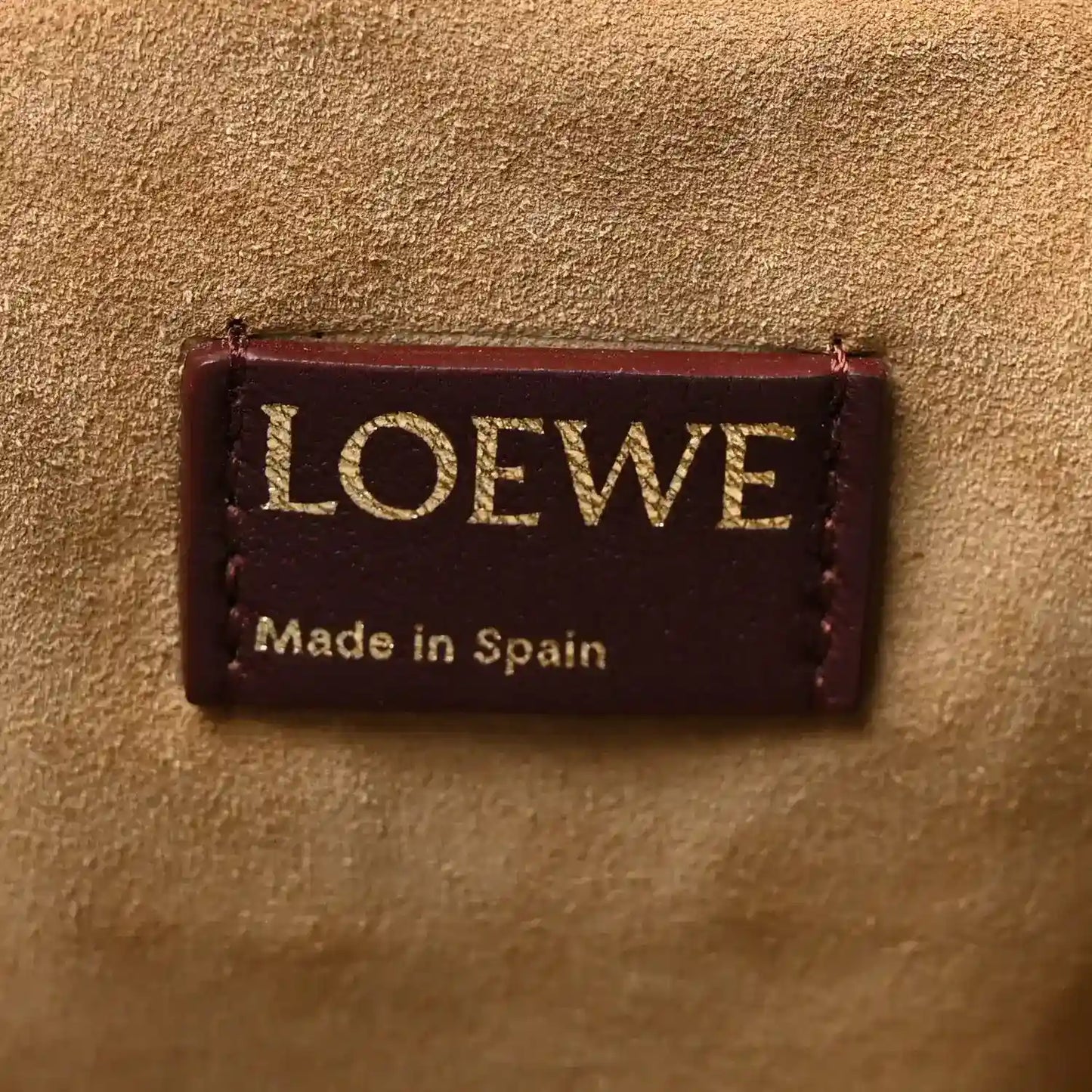 Loewe leather clutch label with “Made in Spain” text