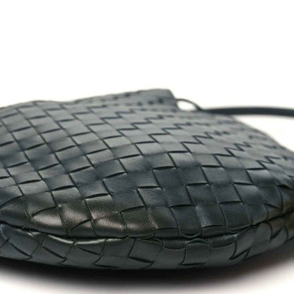 Close-up of dark green woven leather hobo top edge and handle loop