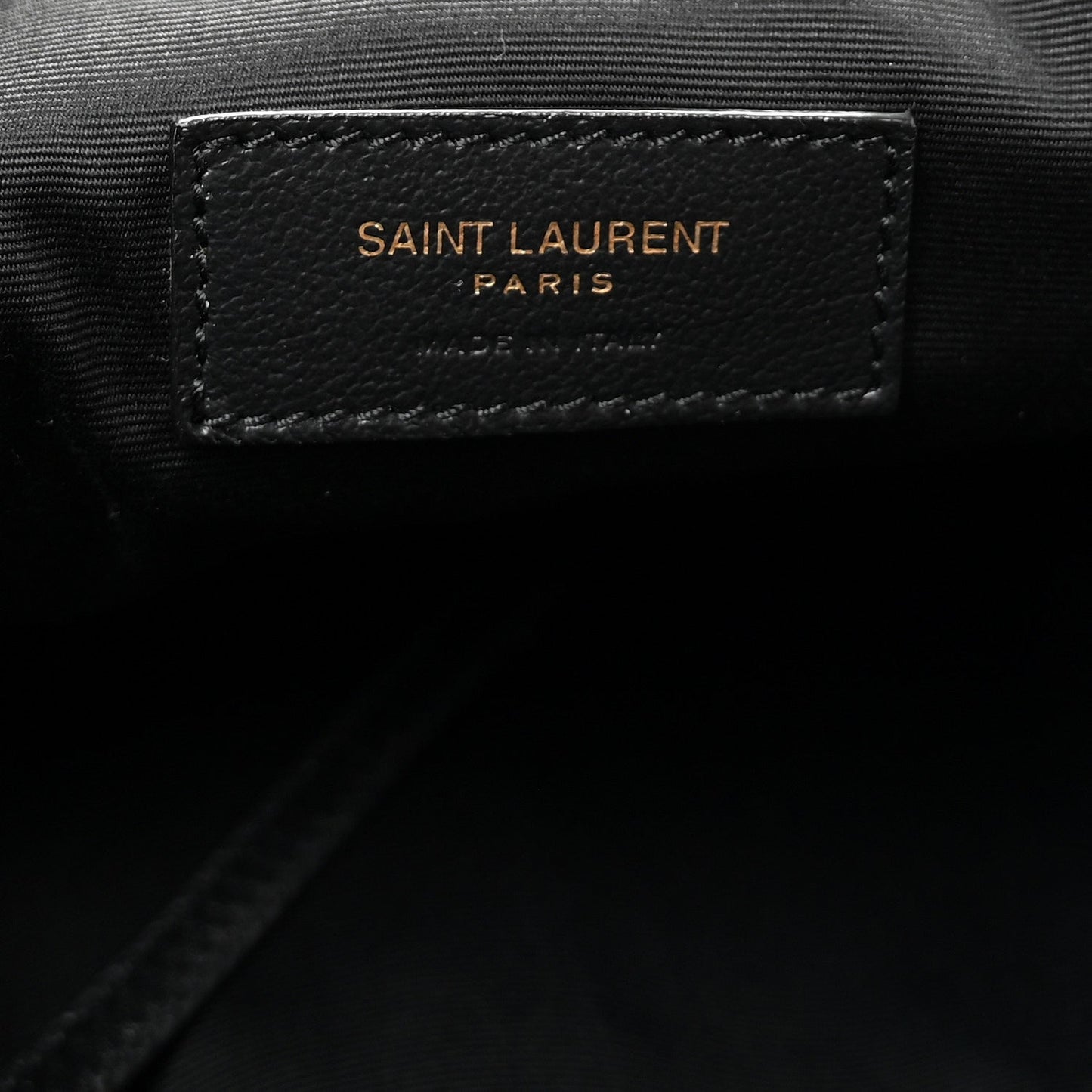 Black leather brand patch reading SAINT LAURENT PARIS on tote lining.