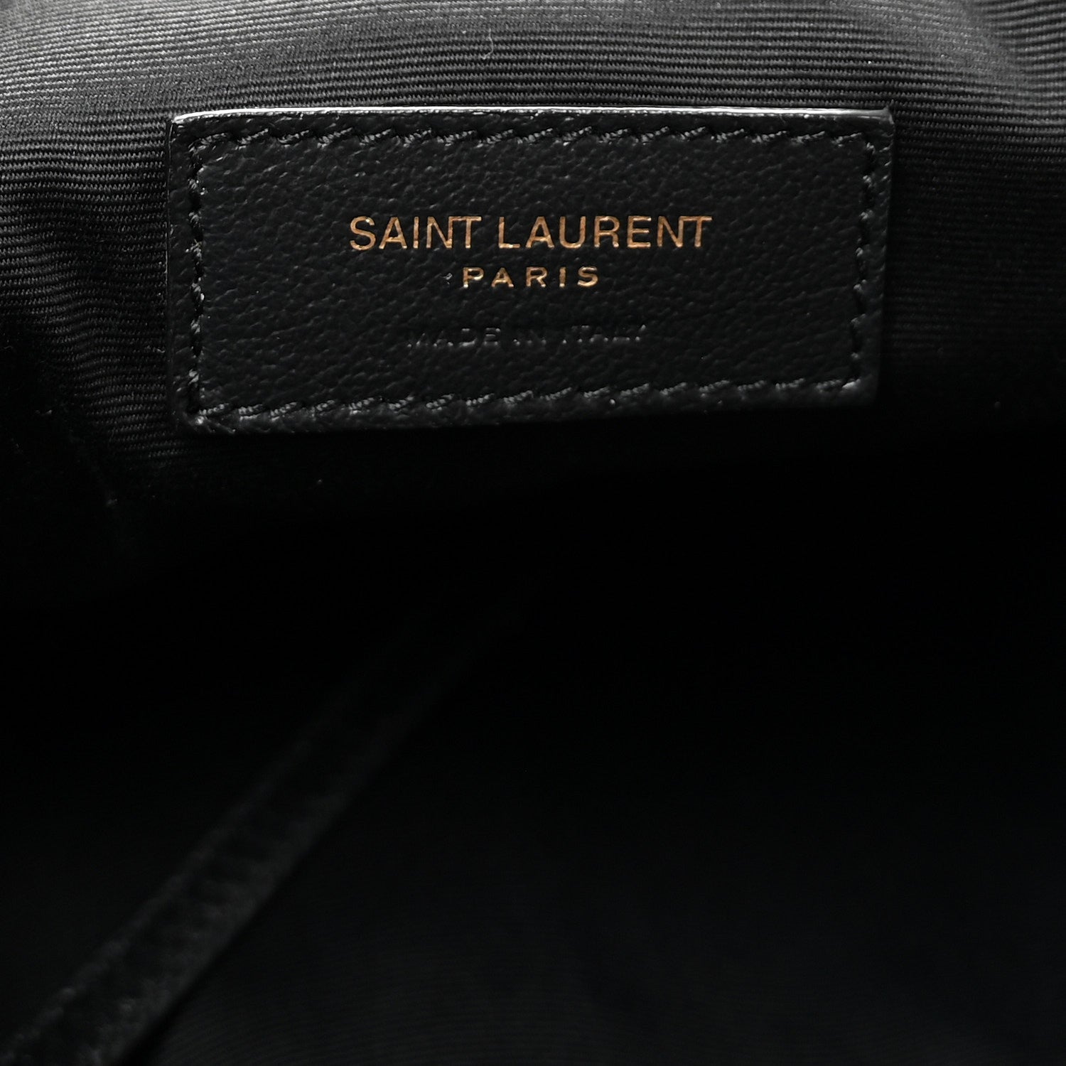 Black leather brand patch reading SAINT LAURENT PARIS on tote lining.