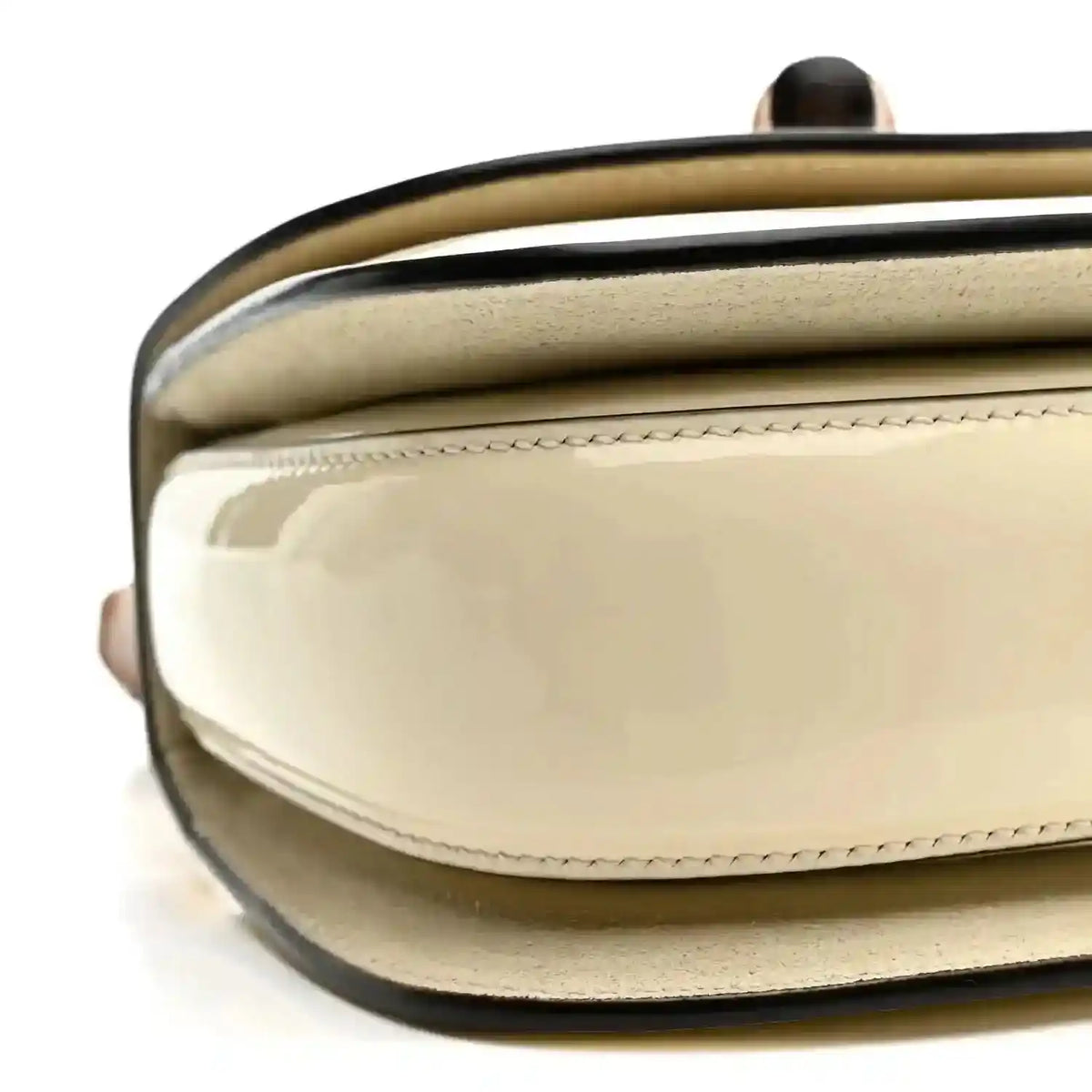 White mini handbag with glossy front panel and stitched flap edge
