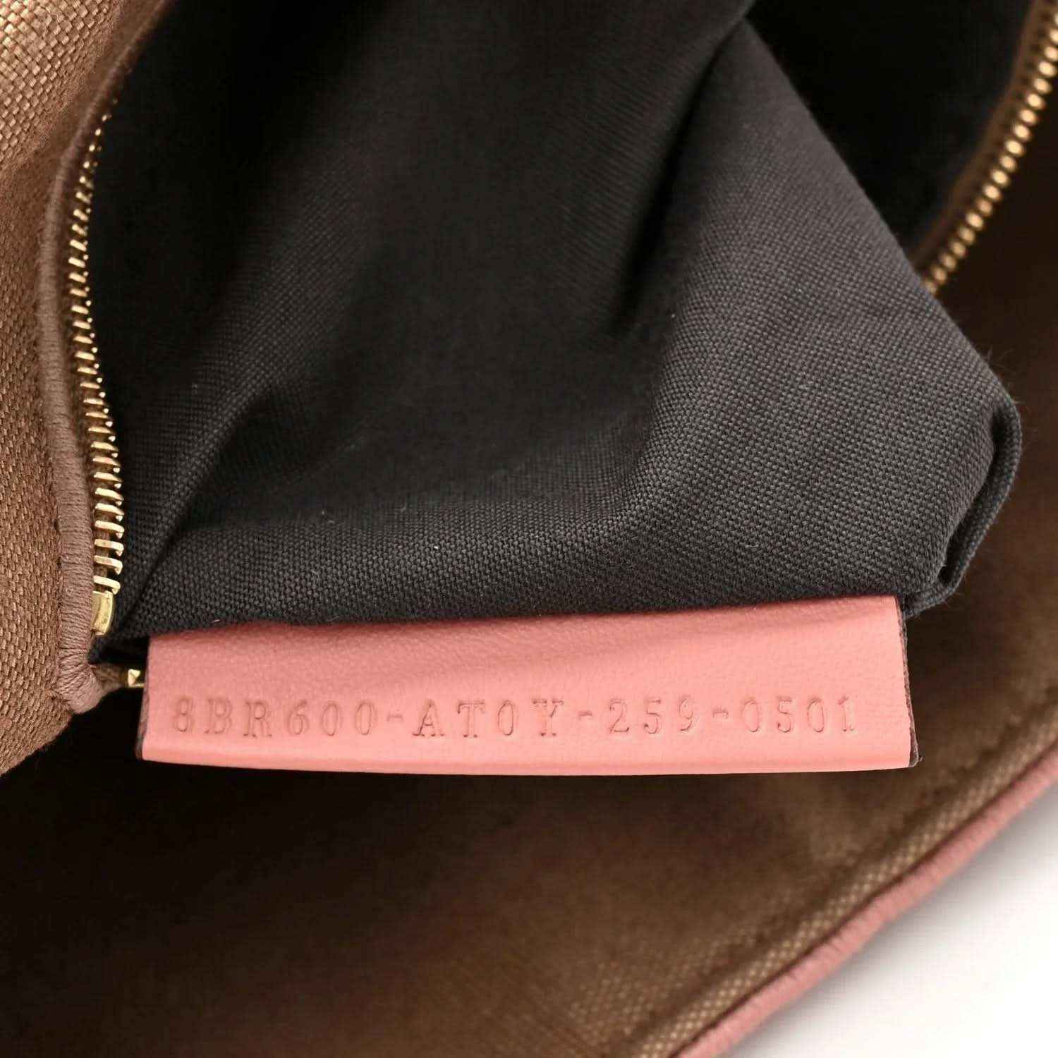Fendi baguette shoulder bag interior seam with pink fabric tag and zipper trim