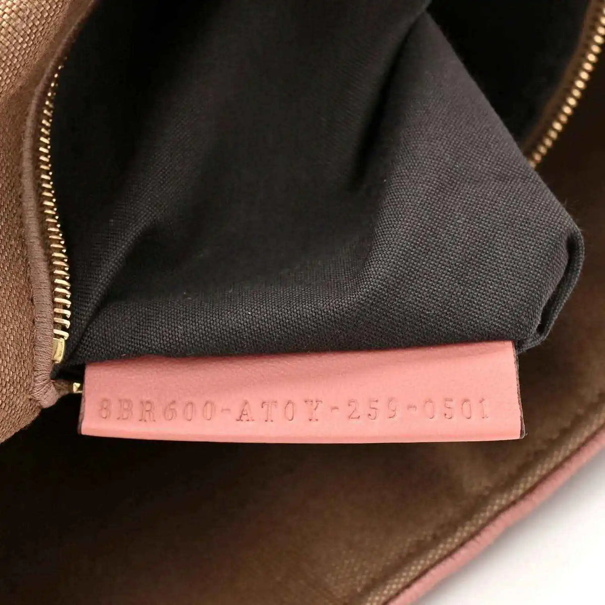 Fendi baguette shoulder bag interior seam with pink fabric tag and zipper trim