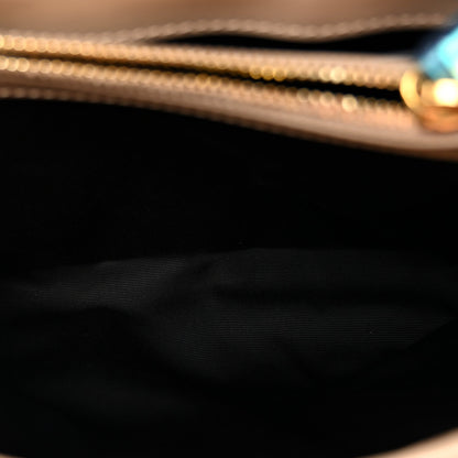 Satchel interior lining close-up with dark fabric and gold chain hardware edge