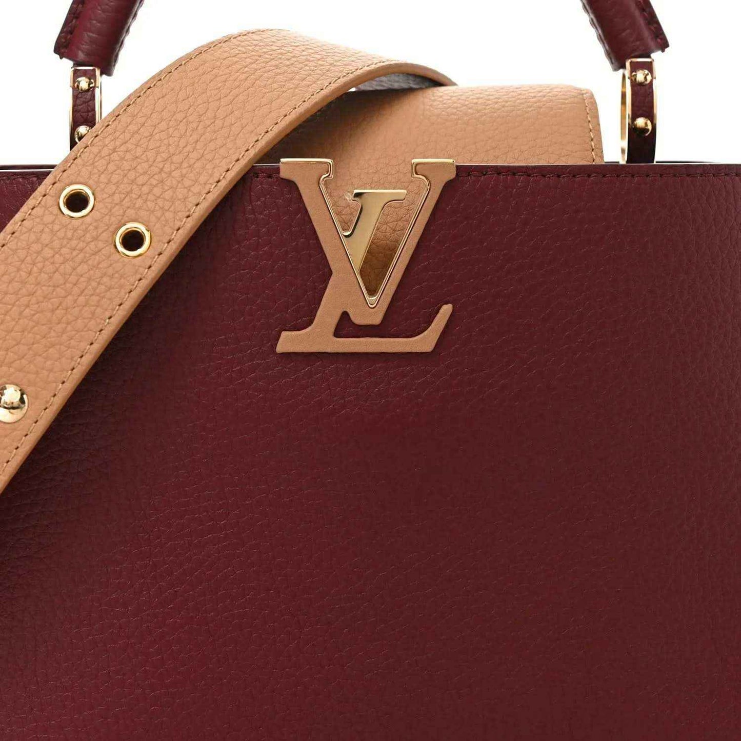 Bordeaux leather handbag with tan top handle strap and gold Louis Vuitton emblem.