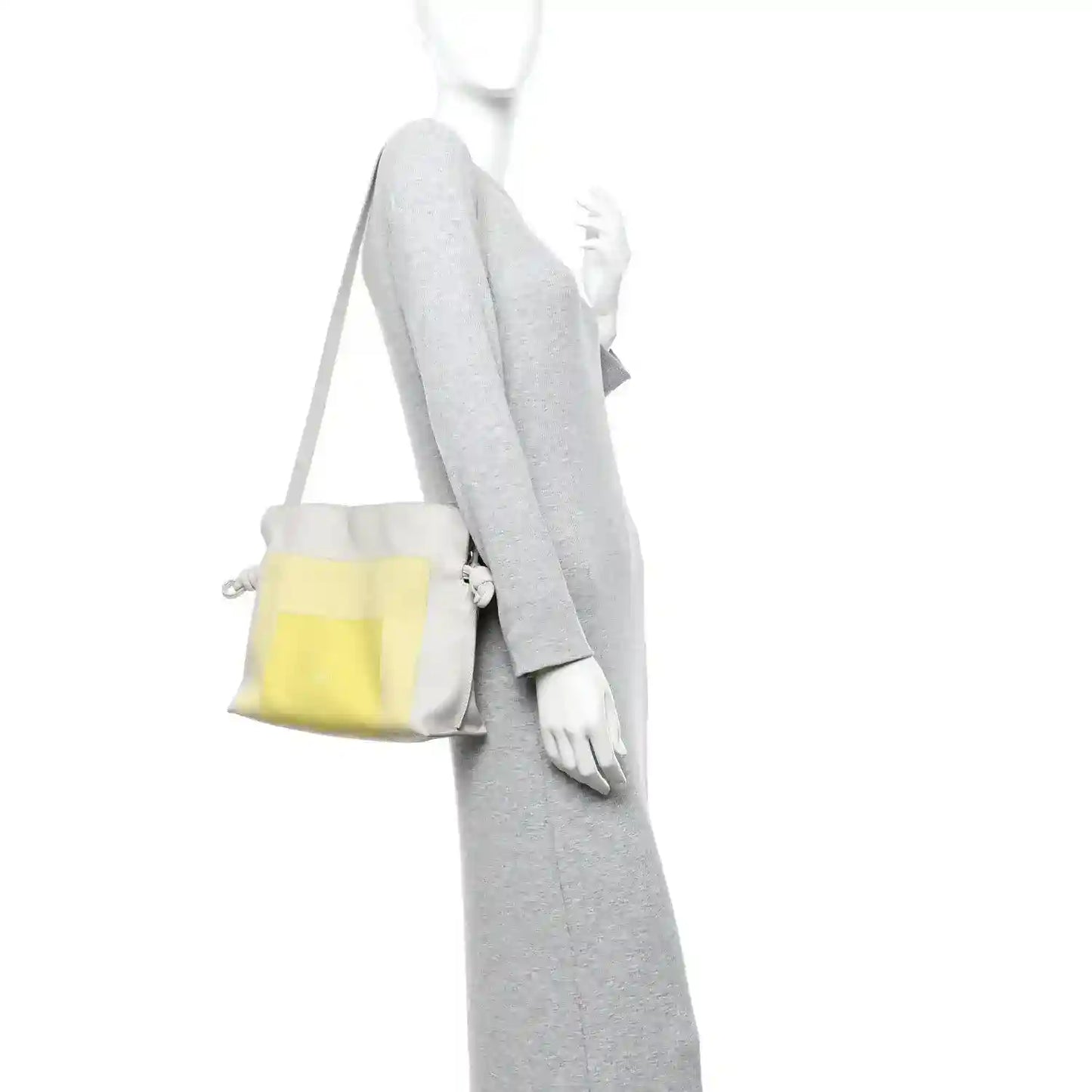Knot clutch carried crossbody with pale grey body and light citrine front panel